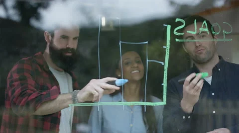 4K Young professional team in business startup drawing graph on window Stock Footage