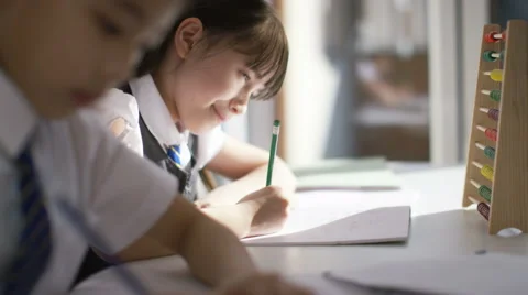 4K Young school children in class with little girl using an abacus Stock Footage 61525731