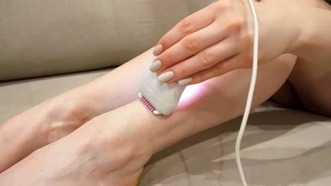 4k. Young slim girl performs epilation of legs at home. Stock Footage 108911925