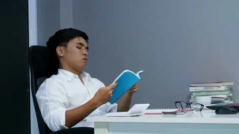 4k of young stressed man studying with book and laptop Stock Footage 93405154