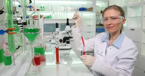 4K Young student smiling looking camera in chemistry lab development tube studie Stock Footage 78776495