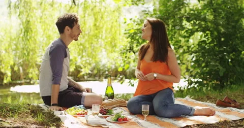 4k, Young woman proposes marriage to her boyfriend whilst on a picnic. Stock Footage