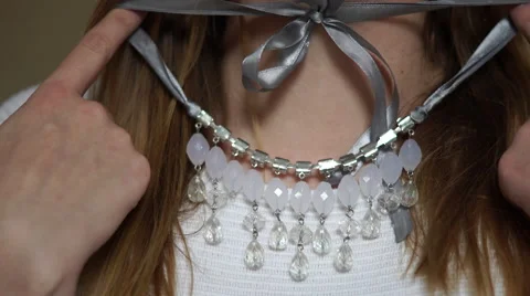 4K young woman trying on necklace Stock Footage 59798684
