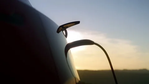 4K zero emission electric car charging with beautiful golden clouds at sunset Stock Footage 170474190