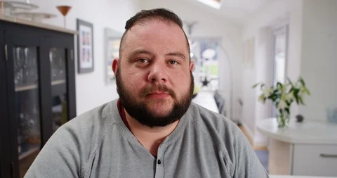 4K Zoom out from close up, portrait of depressed man looking directly at camera Stock Footage 88625614