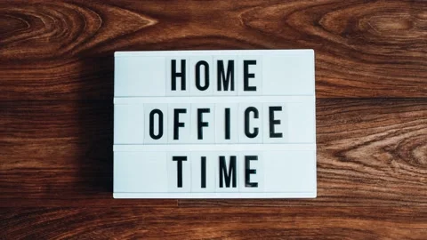 4k zoom in out lightbox with text HOME OFFICE TIME in front wooden background Stock Footage 218589464