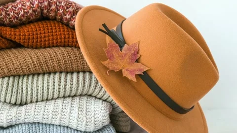 4k zoom in out Stack of cozy knitted warm sweater with Autumn fall maple leaf Stock Footage 222926220