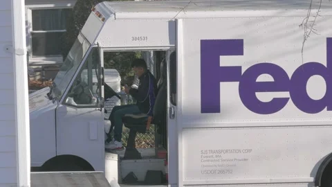 4k60fps, FedEx driver checks location of next package delivery stop Stock Footage 144453564