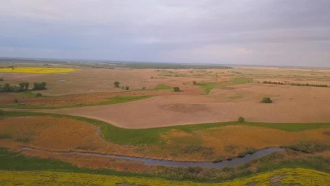 4k.Aerial. Landscape with  color fields and small river Stockbeeldmateriaal 90490641
