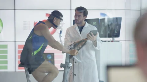 4KAthlete in scientific research program being tested by scientist in white coat Stock Footage 64863432