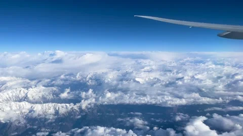 4K,flying over snow capped mountain with cloud,airplane window view Stockbeeldmateriaal 244986084