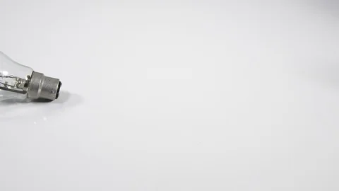 4Kglass Light bulb rolling on white surface background, moving object, energy Stock Footage 90187051