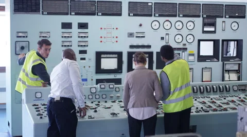 4KWorkers in power plant control room looking at control panel &amp; checking system Stock Footage 63276146
