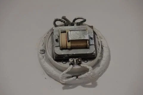 4S3A0516Old switch on a white background. Old switch in the wall. Stock Photos