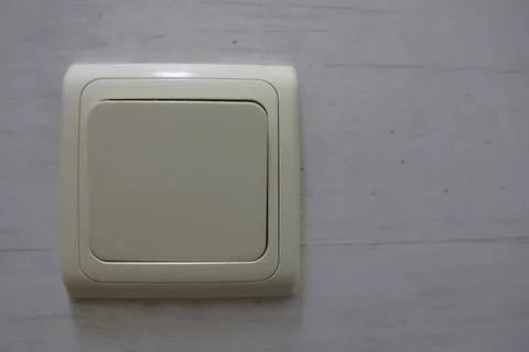 4S3A0752Electrical light switch on a white wall background. Close up. Фото