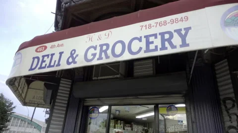 4th Ave Deli and Grocery store sign on corner in Brooklyn NYC Stock Footage