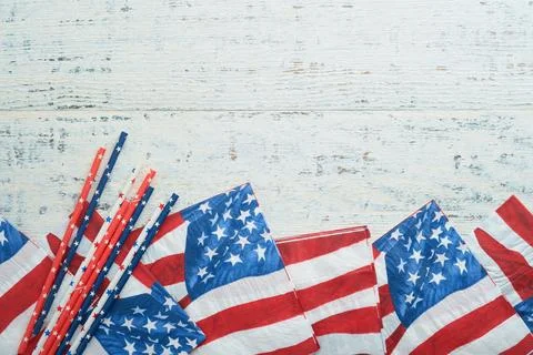 4th of July background. US flag paper napkin and picnic cocktail straws on ol Stock Photos