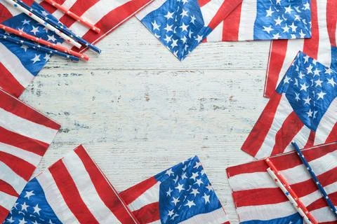 4th of July background. US flag paper napkin and picnic cocktail straws on ol Stock Photos