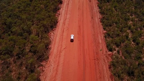 4WD car driving on dirt road in Australia's outback Stock Footage