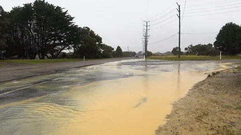 4WD SUV driving through flooded intersection on country road in Australia. Stock Footage 87646257