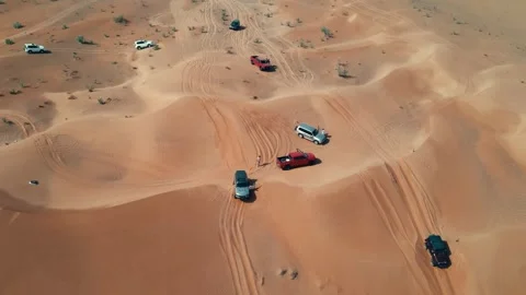4WD vehicles drive across the dunes during a desert safari in the UAE Stock Footage 333482001