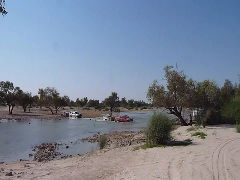 4WDS CROSSING DESERT RIVER Stock Footage 100385065