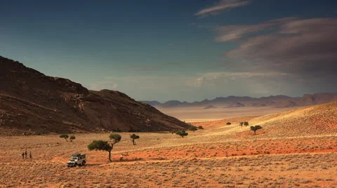 4X4 AND TRAVELLERS IN WIDE DRAMATIC VALLEY HD Stock Footage 45344823