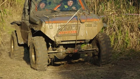4x4 buggy covered in mud during an off-road race Stock Footage 345496033