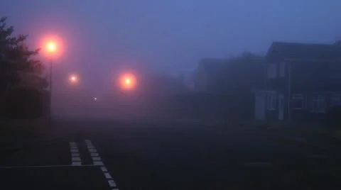 4x4 car drives slowly down foggy street 動画素材 14815501