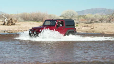 4x4 car, Red, driving through a river. Video stock 213489607