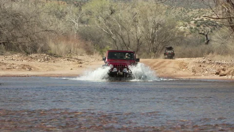 4x4 car, Red, driving through a river towards the camera. Stock Footage 213498805