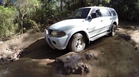 4x4 driving over big stone on serious offroad track Stock Footage 61485102