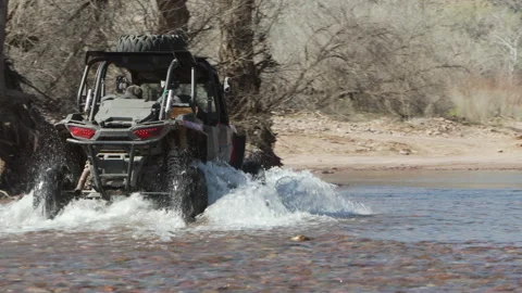4x4 side by side buggy crossing the river Stock Footage 213502308