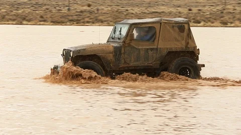 4x4 Splashing Through Mud - Shallow Depth of Field Stock Footage 107074416