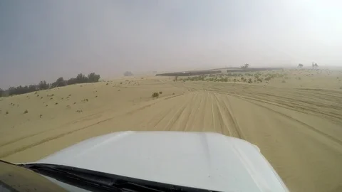 4x4 SUV car driving through the sand dunes in the desert of abu dhabi Stock Footage 73176709