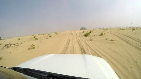 4x4 SUV car driving through the sand dunes in the desert of abu dhabi Stock Footage 73176733