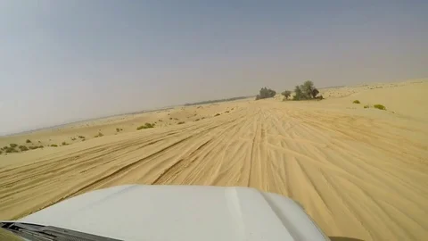 4x4 SUV car driving through the sand dunes in the desert of abu dhabi Stock Footage 73177786