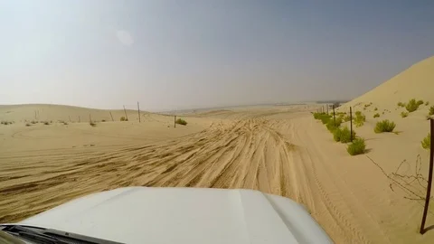 4x4 SUV car driving through the sand dunes in the desert of abu dhabi Stock Footage 73177802
