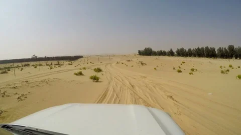 4x4 SUV car driving through the sand dunes in the desert of abu dhabi Stock Footage 73179625