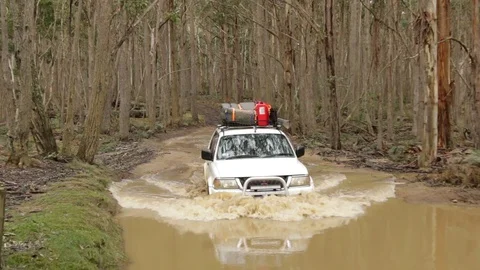 4x4 vehicle driving through deep water hole Stock Footage 71604098
