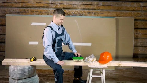 4Young handsome builder very hungry at the construction site. He greedily dines  Stock Footage 102778462