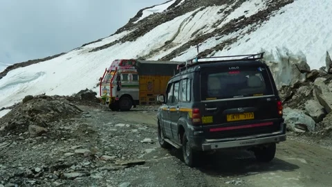 5-6-24; Vehicles reverse on challenging snowy mountain terrain in Ladakh, India Stock Footage 277284713
