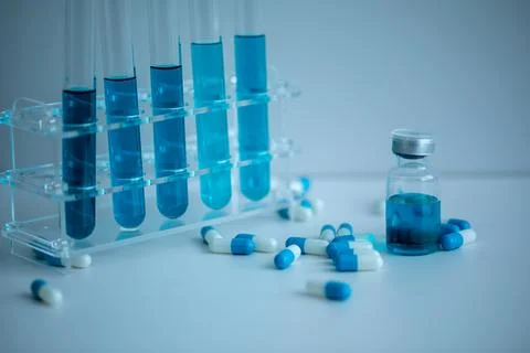 5 blue test tubes placed in the medical tube rack. Stock Photos