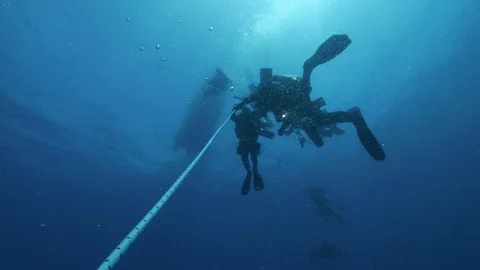 5 divers begin to ascend using guide line with which they descended,Medsea,Italy Stock-Footage 115533802