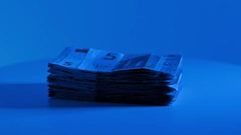 5 Euro Banknotes Rotate on Display Platform Under Dramatic Blue Studio Lighting Stock Footage 344095844