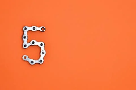 5 Five made from chain on vibrant orange background Stock Photos