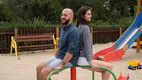 5 Having fun on a children playground - a young people couple recalling their Stock Footage 93752605