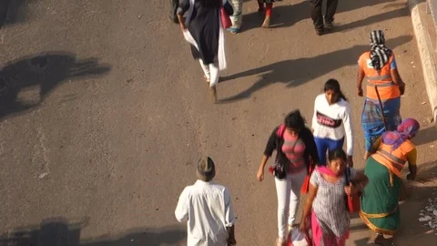 5-High-Angle-View-woman-sweeping-street-busy-bus-stop-people-traffic Stock Footage 89420283