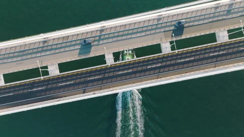 5.the sight of a busy ship passing under a bridge Stock Footage 303517124