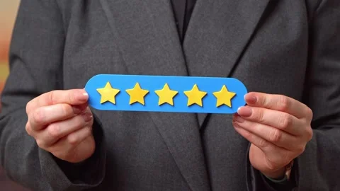 A 5 star plaque in a woman's hand. Popularity and customer satisfaction in Stock Footage 339028102